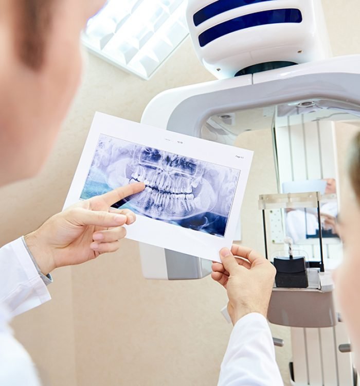 The doctor shows the patient an x-ray image. Computer diagnostics. dental tomography